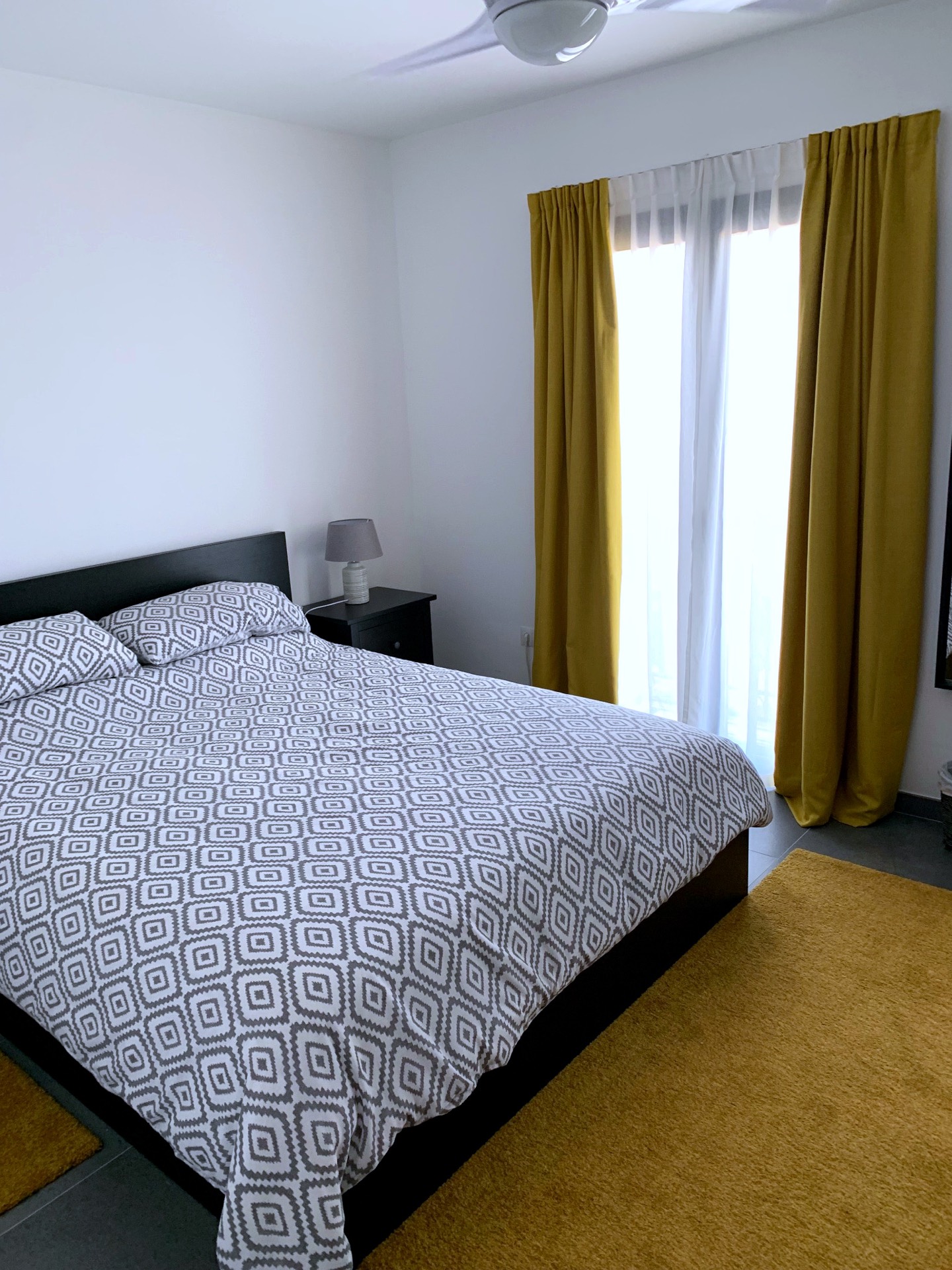 Double bedroom with yellow curtains