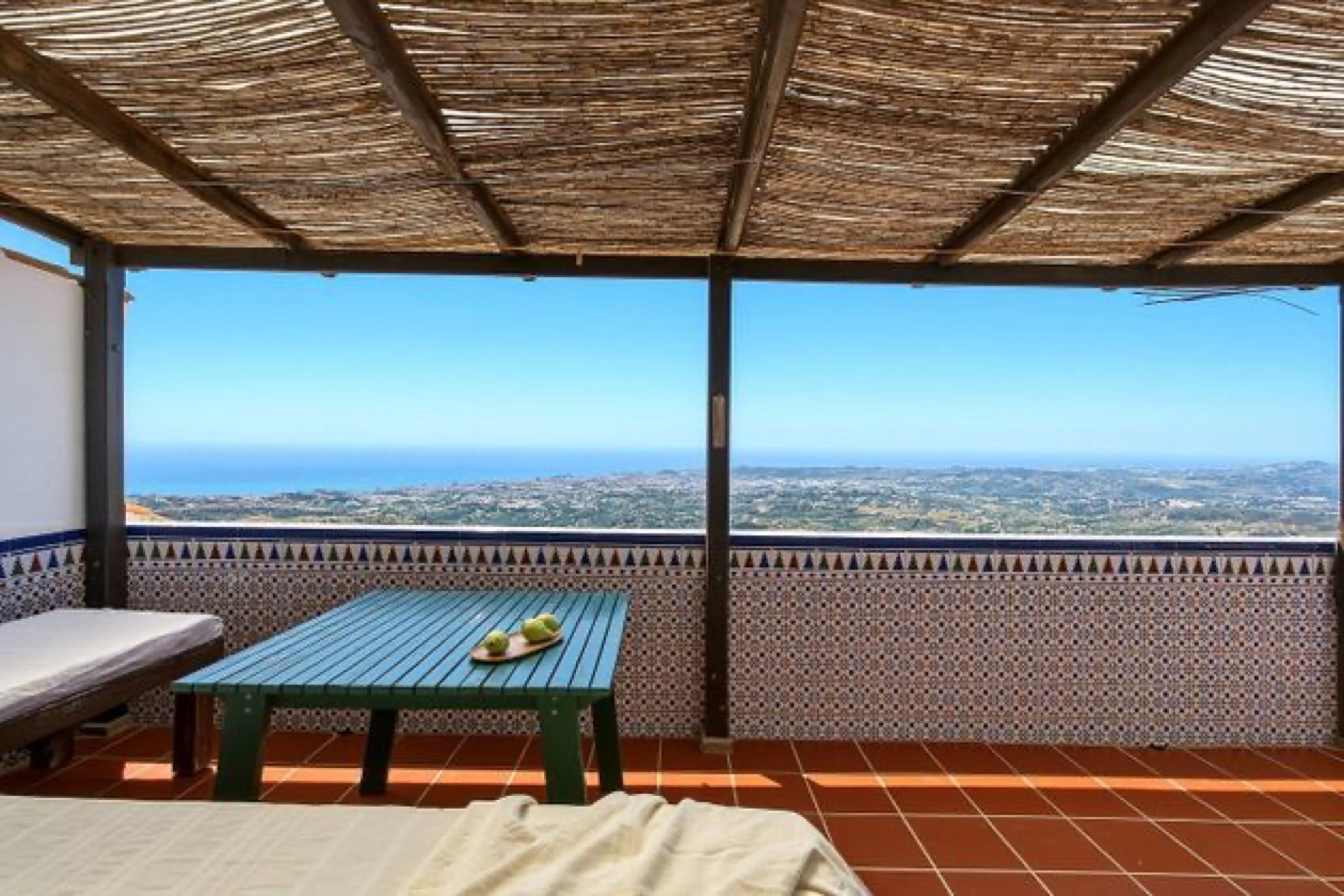 Covered terrace dining area with panoramic sea views